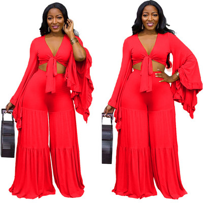 Uue mudeli naiste komplekt, millel on lühike pikkade varrukatega topp ja laiad kõrge vöökohaga püksid