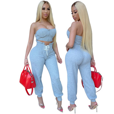 Naiste kaheosaline rinnakorv ja vöökohal lipsudega püksid