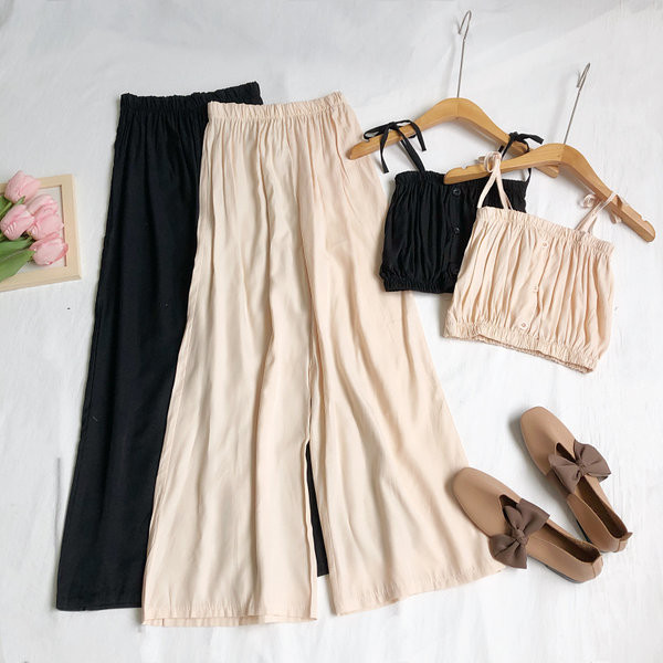 Sieviešu komplekts no divām daļām platām biksēm un topiņa ar plānām lencēm