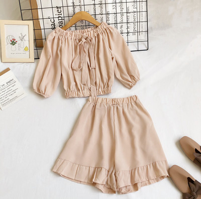 Uue mudeli naiste komplekt lühikese pluusi ja kõrge vöökohaga pükstega