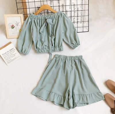 Uue mudeli naiste komplekt lühikese pluusi ja kõrge vöökohaga pükstega