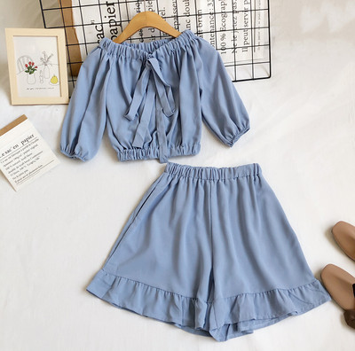 Uue mudeli naiste komplekt lühikese pluusi ja kõrge vöökohaga pükstega