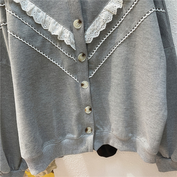 Ümmarguse dekoltee ja nööpidega halli ja musta värvi vabaaja naiste kardigan