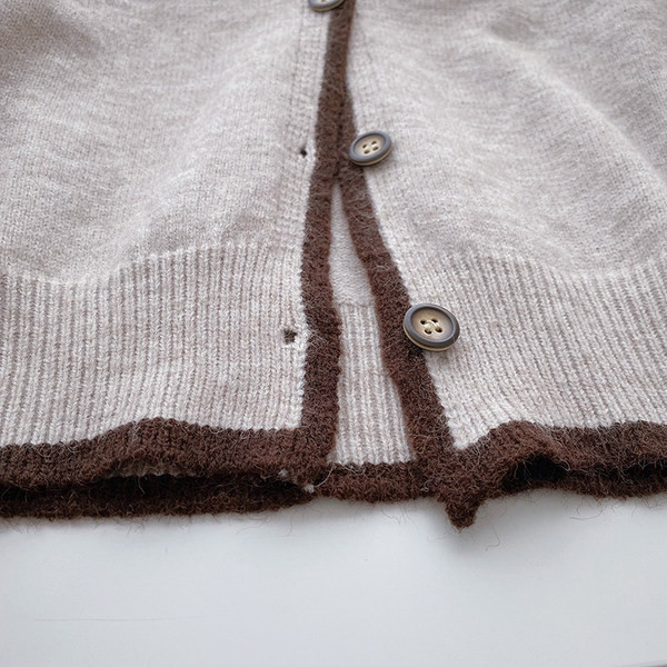 Μοντέρνα  γυναικεία ζακέτα  με οβάλ λαιμόκοψη και κορδέλα