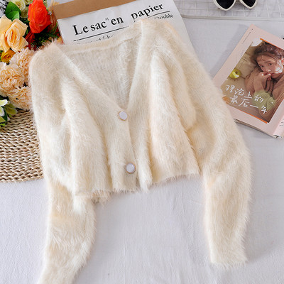 Női pehelymellény gombokkal és spitz nyakkivágással