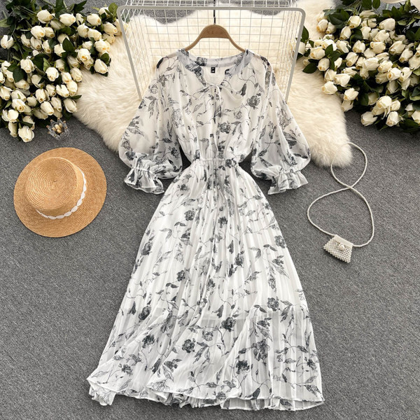 Moteriška ilga suknelė su gėlių raštu ir kaspinu