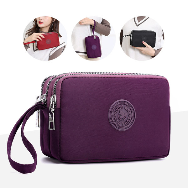 Mala torbica od tkanine sa patentnim zatvaračem i ručkom za ruku