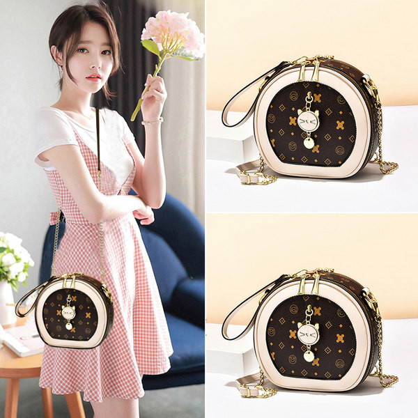 Moderna mala torbica okruglog oblika s metalnim ukrasom