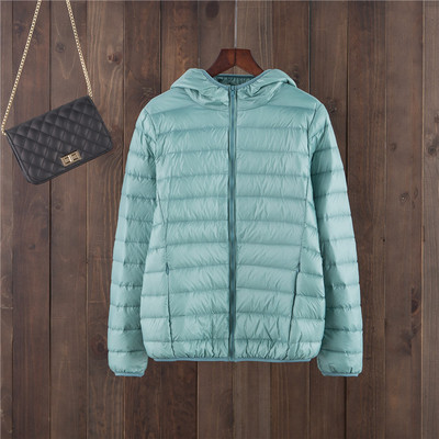 Egyszínű női kabát kapucnival és cipzárral